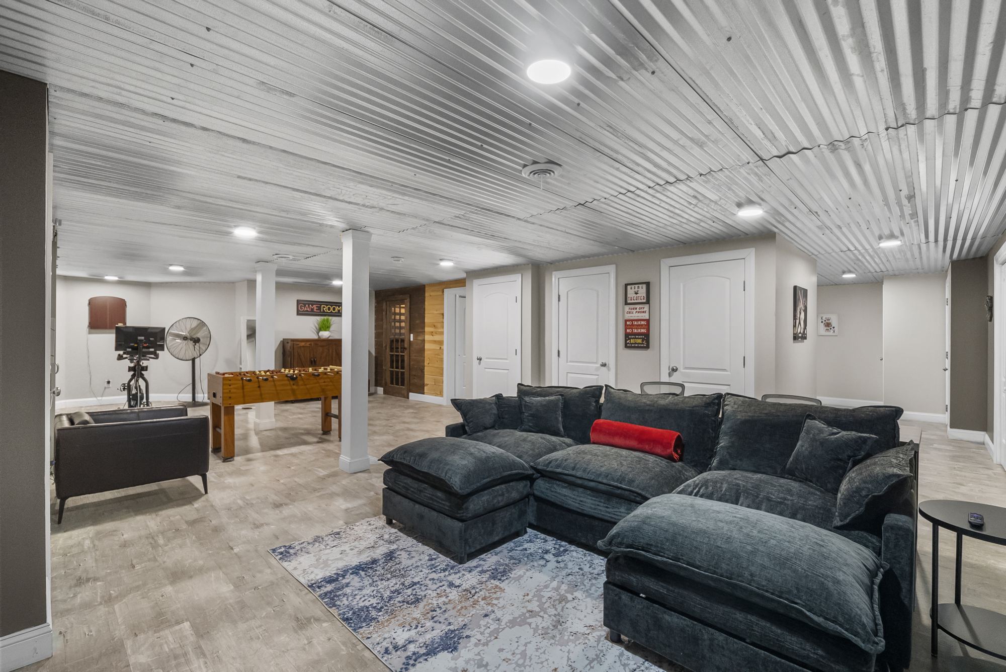 Lower-level lounge with sectional and screen